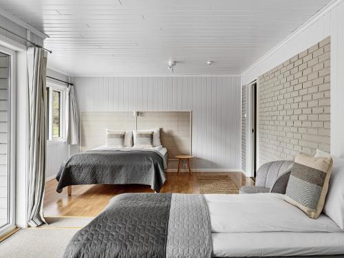 a bedroom with a bed and a brick wall at Eidfjord Hotel in Eidfjord