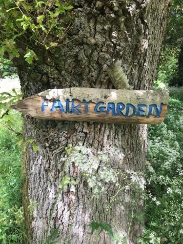 a wooden sign attached to a tree at Luxury 4 bedroom Lodge Mount Juliet Estate Thomastown Kilkenny in Thomastown