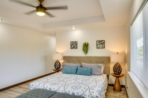 a bedroom with a bed with blue pillows at Keaau Getaway with Patio, 3 Mi to Shipman Beach! in Keaau