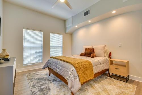 a bedroom with a bed and two windows at Luxe Pasadena Casita with Fireplace and Grill in Pasadena