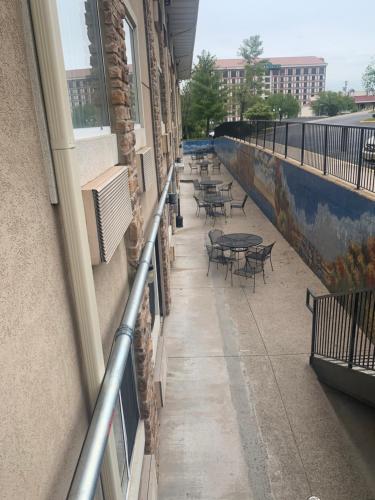 a balcony of a building with tables and chairs at The Boardwalk Inn in Branson