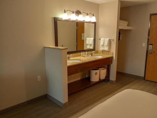 a hotel bathroom with a sink and a mirror at Country Inn & Suites by Radisson, Portland International Airport, OR in Portland