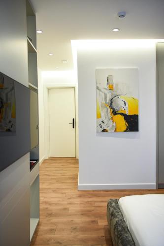 a bedroom with a bed and a painting on the wall at The Wilson Tirana in Tirana