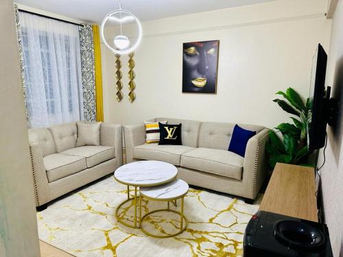 a living room with a couch and a table at Vob cosy home in Eldoret