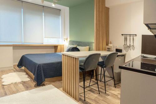 a bedroom with a bed and a table and chairs at City Centre Suites in Komotini
