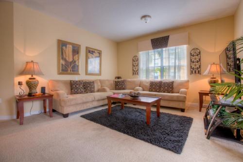 a living room with a couch and a table at Palm Villa in Orlando