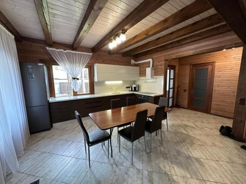 a kitchen and dining room with a table and chairs at Dacha 6 in Voropayev