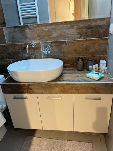 a bathroom with a white sink on a wooden counter at City Centre Suites in Komotini