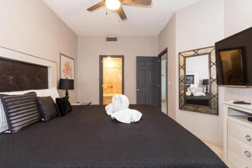 a bedroom with a bed with a white towel on it at Sonoran Sea 310-W - Modern 1 bedroom in Puerto Peñasco