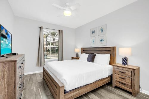 a bedroom with a large bed and a tv at Ground-Floor Vista Cay Condo Near Clubhouse Pool in Orlando