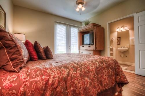 a bedroom with a large bed with red pillows at Resort Townhome: Perfect Orlando Vacation Spot in Orlando