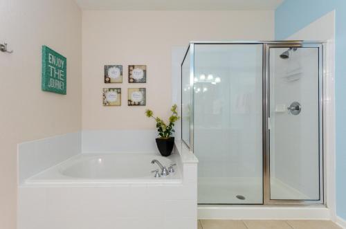 a white bathroom with a shower and a sink at Treasure Palace in Orlando