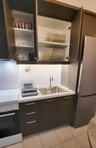 a kitchen with a sink and a refrigerator at Stelios Studios Sougia in Sougia