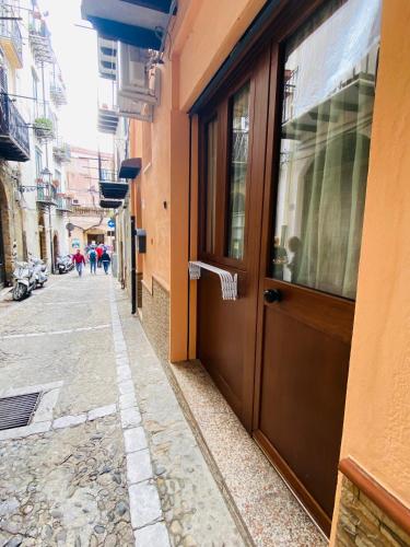 a door on the side of a building on a street at Casa Alice in Cefalù