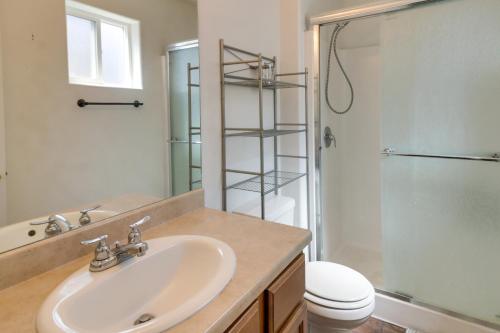 a bathroom with a sink and a shower and a toilet at Cozy Colorado Retreat with Patio, Grill and Fire Pit! in Alamosa