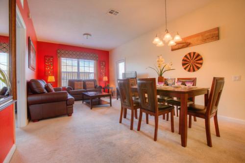 a dining room and living room with a table and chairs at Lofty Lodge in Orlando