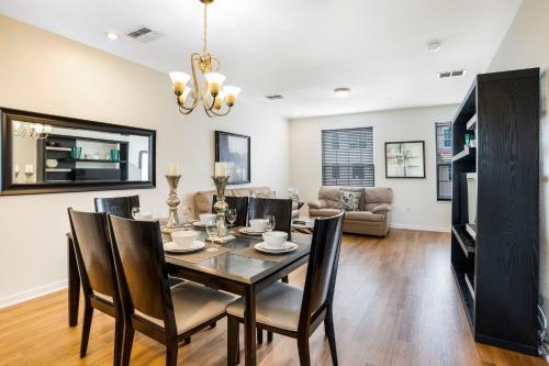 a dining room and living room with a table and chairs at 3-Story Townhome at Vista Cay Resort in Orlando