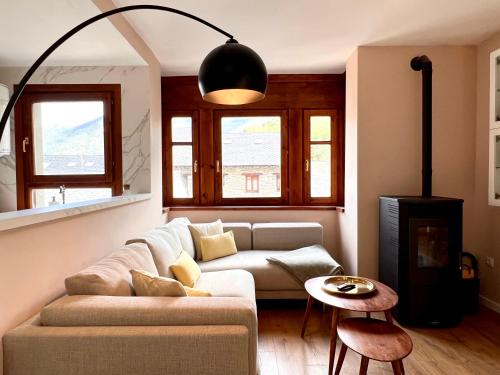 a living room with a couch and a fireplace at Dúplex La Roca in Espot