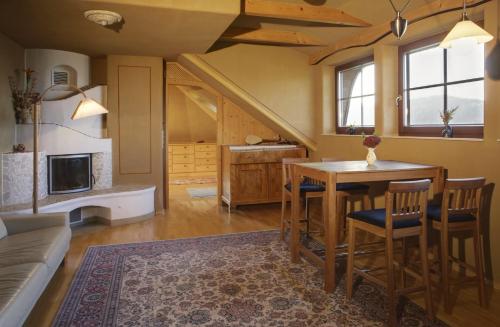 a living room with a table and chairs and a couch at Biolandhaus Arche in Eberstein
