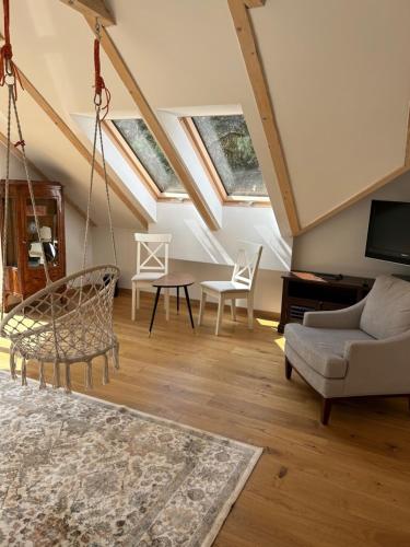 a living room with skylights and a swing at Leśna Residence & SPA in Pisz