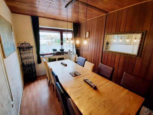 a dining room with a large wooden table and chairs at Spacious Holiday Home in Karl in Eifel with Sauna in Karl