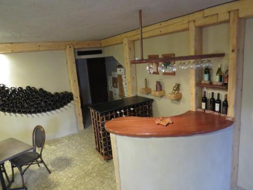 a wine tasting room with a bar and wine bottles at Dror Winery in Kefar Shammay