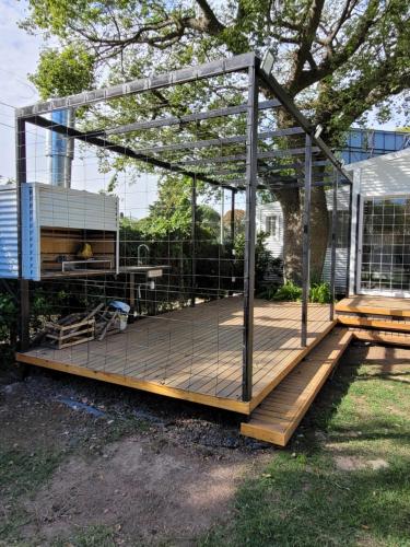 a wooden deck with a metal structure on it at Casa Mojada in Rosario