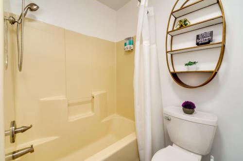 a bathroom with a toilet and a shower and a mirror at Bowling Green Vacation Rental Near WKU and Downtown! in Bowling Green