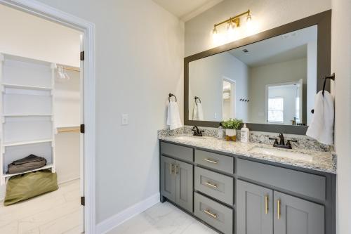 a bathroom with a sink and a mirror at Biking Haven Charming Bella Vista Home with Games! in Bella Vista