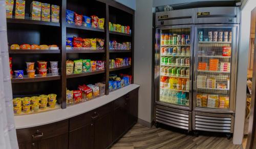 a store with a refrigerator and shelves full of food at La Quinta by Wyndham Milwaukee Delafield in Delafield