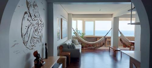 a living room with a couch and a hammock at COBAR0108 - Edifício Oceania in Salvador