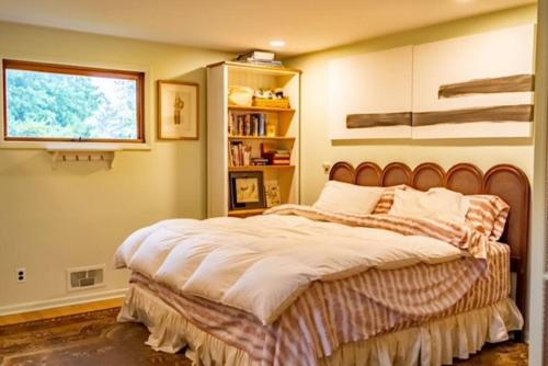 a bedroom with a large bed with a window at Quiet place with easy access NYC in River Edge