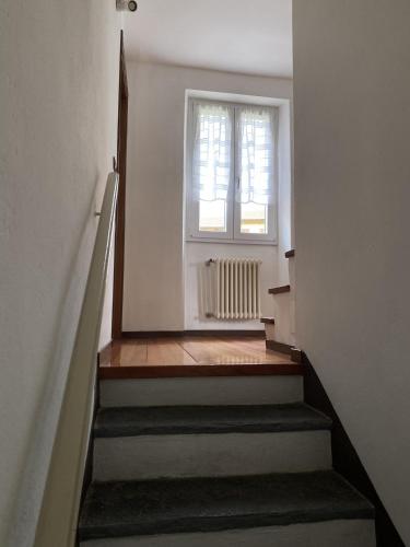 a stairway with a window and a stair case at Casa Dilma in Lenno