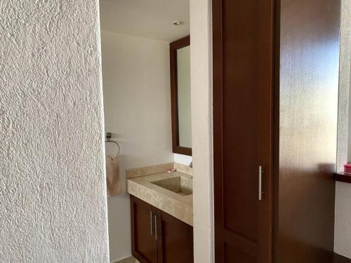 uma casa de banho com um lavatório e um espelho em Suite Misión Juriquilla #5 em Juriquilla