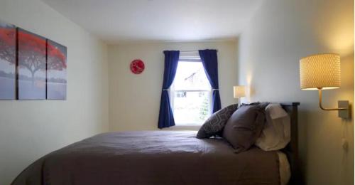 a bedroom with a bed and a window at Walk 2mins to West Point Academy! Private 2br on Main in HEART of Highland Falls in Highland Falls