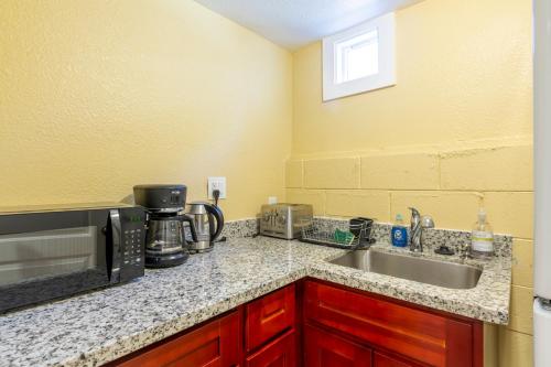 a kitchen counter with a sink and a microwave at @ Marbella Lane - 2BR Cozy LwrLvl in DTWN SJ in San Jose