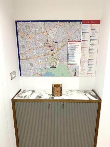 a map on a wall with a box on top at The Wilson Tirana in Tirana
