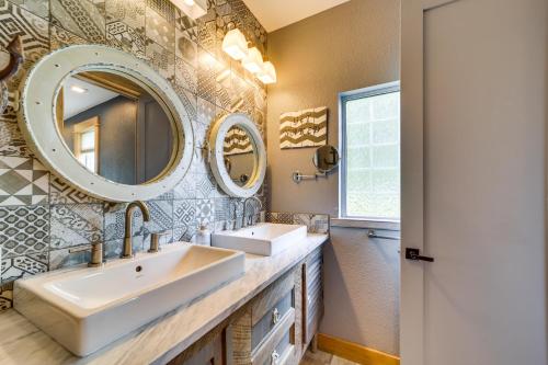 a bathroom with two sinks and two mirrors at Lakefront Afton Home with Hot Tub and Game Room! in Afton