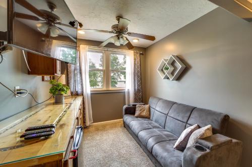 a living room with a couch and a table at Lakefront Afton Home with Hot Tub and Game Room! in Afton