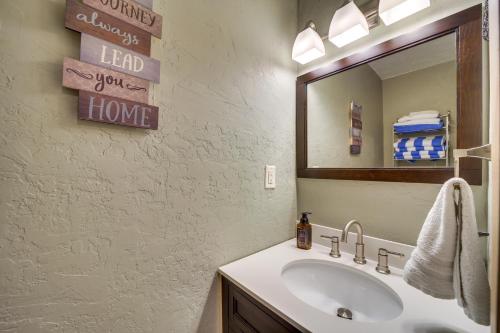 a bathroom with a sink and a mirror at Lakefront Afton Home with Hot Tub and Game Room! in Afton