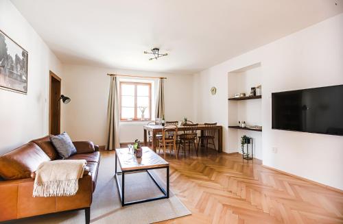a living room with a couch and a table at Apartmán Masaryk in Český Krumlov