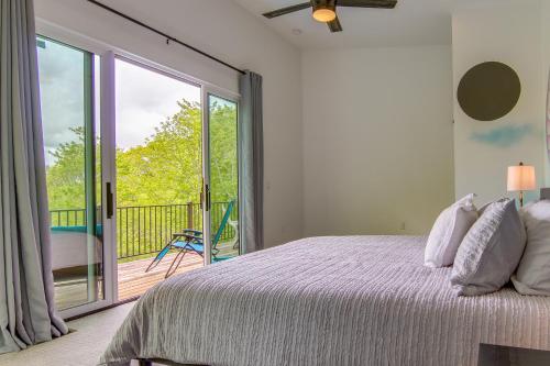 a bedroom with a bed and a balcony at Modern Fairview Retreat Spacious Deck and Mtn View! in Fairview