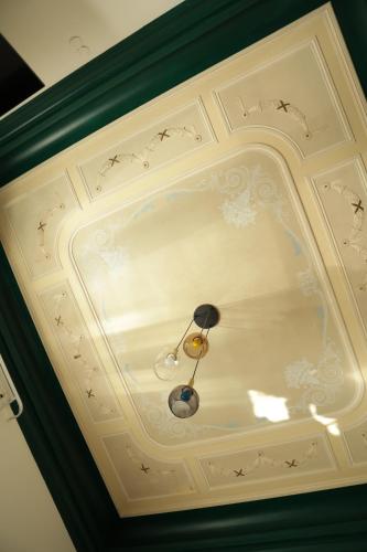 a white coffered ceiling with a light on it at PALAZZO FIACCADORI - Historical Palace in Reggio Calabria