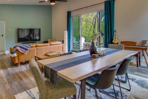 a living room with a large wooden table and chairs at Modern Fairview Retreat Spacious Deck and Mtn View! in Fairview