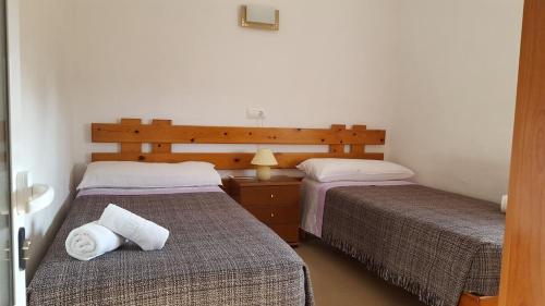 a bedroom with two beds and a table with a lamp at CASA PATY, Estudio rural. Sant Ferran FORMENTERA in Sant Ferran de Ses Roques