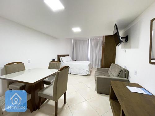 a living room with a dining table and a bed at Apartamento aconchegante com píer e acesso ao Mar in Salvador