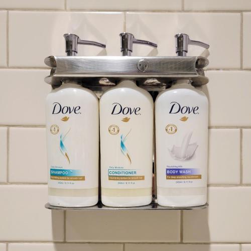 a shelf with three bottles of dooe in a bathroom at Staybridge Suites Baltimore - Inner Harbor, an IHG Hotel in Baltimore