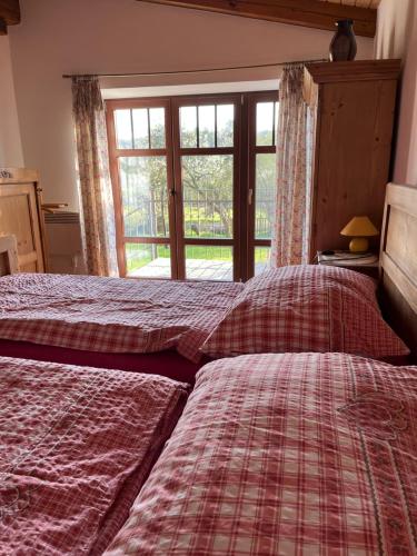 a bedroom with two beds and a window at Villa Beata in Radvánovice