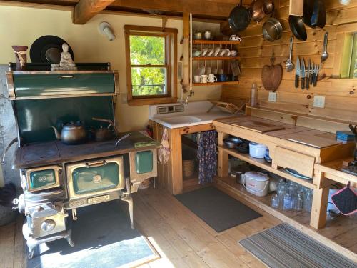a kitchen with an old stove and a sink at Renovated Barn 100 Acres For Retreats & Weddings in Hardwick