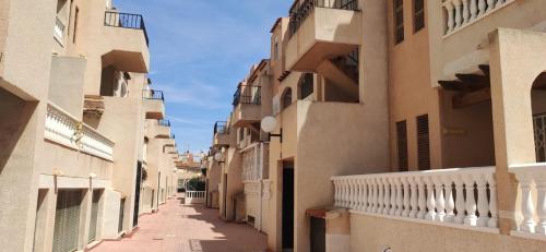 an alley between two buildings in a city at Villas Del Mar 2-bedroom Apartment with Swimming pool in Torrevieja